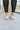 The Got To Go Sneaker features an ivory corduroy upper with grey colored suede paneling, a grey colored suede heel, a camel colored heel tab, two camel colored side stripes, and a lace-up closure.