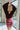 Frontal view of the Take Me Out Bodysuit that features a burgundy velvet material, a surplice neckline with a clasp closure, a long sleeve with a smocked wrist, and a bikini bottom with a snap closure.