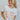 Front view of model wearing the Howdy Cropped Graphic Tee, that features a white cotton material, a round neck, a short sleeve, pink, orange, and purple text that reads "Howdy", and a raw hem