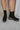 The Better Than The Rest Bootie features a black colored suede upper, dual paneling on the shaft with elastic gores, a platform lug sole, a stacked platform heel, and a heel tab for easy on-off wear.