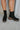 The Better Than The Rest Bootie features a black colored suede upper, dual paneling on the shaft with elastic gores, a platform lug sole, a stacked platform heel, and a heel tab for easy on-off wear.