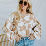 Frontal view of the Switch It Up Sweater that features a tan knit material, an ivory geometric print, a round neck, long cuffed sleeves, and a loose fit.