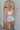 Frontal view of the Let's Go Girls Skort that features a champagne metallic coloring, a thick waist band with adjustable ties, a tiered design, and a shorts lining.