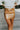 Frontal view of the Picture Perfect Mini Skirt that features a gold colored PU material, a high-rise fit, a back zipper closure, and a mini length.