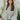 Frontal view of the More Than Words Top that features an ivory colored material, a yellow and green plaid pattern, a round neck, a long sleeve, a babydoll silhouette, an adjustable tie cinched front, and a flowy fit