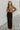 Frontal view of the Let's Chat Pants that features a black colored material, a high-rise waist, a sweetheart cut waist hemline, a seam down the front legs, a wide leg fit, and a back zipper closure.