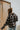 Back view of the In Rhythm Plaid Mix jacket that features a navy material with a camel and ivory plaid pattern, a collar neck, a button-up front, two front pockets, and long cuffed sleeves