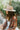 The Heading South Hat is a wide brim hat featuring a khaki fabric, a brown and white aztec pattern belt, and adjustable ties within for different fits.