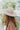 The Heading South Hat is a wide brim hat featuring a khaki fabric, a brown and white aztec pattern belt, and adjustable ties within for different fits.