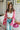 Frontal view of the Simple Times Cardigan that features a pink knit material with an ivory checkered pattern, an open front, and oversized long sleeves.