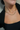 Close up view of model wearing the Emilia Gold Slinky Single Layer Necklace which features single gold slinky layer with adjustable clasp closure.