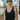 Front view of model wearing the Best Of The Best Tank Top that has double-layered black knit fabric, a v-neckline and back, and a sleeveless design