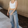 Full body front view of model wearing the Ready To Go Pants that have grey lightweight fabric, white stripe side details, an elastic waistband, two front pockets and straight leg pants