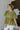 Front view of model wearing the How Romantic Top that has olive green fabric, a peplum body style, a round neckline, short balloon sleeves, and a back keyhole with a button closure