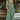 Front view of model wearing the Love Story Midi Dress that has green fabric, midi length, side pockets, a smocked upper body, a scoop neckline, and ruffle straps.