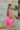 Side view of model wearing the She's Everything Dress that has hot pink fabric, mini length, a three-tiered ruffle skirt, a square neckline, adjustable straps, and a back zipper with a hook closure.