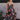 Full body view of model wearing the Beautiful Mess Floral Dress which features black, orange, fuchsia, teal, aqua, green and white fabric, floral print, midi dress, two-tiered body, square neckline, adjustable straps and monochromatic back zipper with hoo