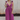 Full body view of model wearing the Moment in Time Jumpsuit which features plum lightweight fabric, plum lining, wide leg pants, criss cross detail at waist, plunge neckline, ruffle straps, corset ties in the back, open back and monochromatic back zipper 