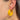 Side view of model wearing the Twisted Up Earrings in Mustard which features matte mustard medium closed hoops with an intertwined design.