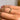 Close up view of model wearing the Unbreakable Chain Ring which features single gold band with chain and clear stones design.