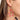 Side view of model wearing the Flower Power Earrings in Multi which features teardrop shaped hoop covered with orange, hot pink and light pink flowers.