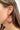 Side view of model wearing the Summer Heat Beaded Earrings which features hot pink, light pink and orange beads, designed in a gold shaped hoop.