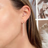 Side view of model wearing the Walk Of Fame Earrings which features gold bars with pearl details.