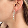 Side view of model wearing the Farrah Rhinestone Earrings which features clear rectangle stones scooped into a circle.