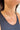 Close up view of model wearing the Heart of Gold Pearl Necklace which features gold chain link with a heart shaped pearl medallion.