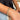 Close up view of model wearing the Athena Gold Bracelet features gold adjustable bangle with hammered design.