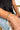 Close up view of model wearing the Athena Gold Bracelet features gold adjustable bangle with hammered design.