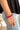 Front view of model wearing the Half and Half Bracelet in Fuchsia which features three stack of stretchy bracelets with small gold beads, small fuchsia beads and large fuchsia beads.