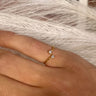 Front view of model wearing the The One I Want Ring which features single gold, separated band with two clear stones.