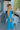 Full body side view of model wearing the Coastal Paradise Dress that has cobalt blue ribbed fabric, midi length, a round neckline, an elastic waistband, and spaghetti straps
