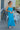 Full body front view of model wearing the Coastal Paradise Dress that has cobalt blue ribbed fabric, midi length, a round neckline, an elastic waistband, and spaghetti straps