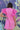 Back view of model wearing the Layla Ruffle Sleeve Dress that has pink fabric, mini length, a round neckline, and short ruffle sleeves.