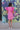 Full body back view of model wearing the Layla Ruffle Sleeve Dress that has pink fabric, mini length, a round neckline, and short ruffle sleeves.