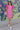 Full body front view of model wearing the Layla Ruffle Sleeve Dress that has pink fabric, mini length, a round neckline, and short ruffle sleeves.