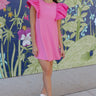 Full body front view of model wearing the Layla Ruffle Sleeve Dress that has pink fabric, mini length, a round neckline, and short ruffle sleeves.