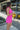 Side view of model wearing the Sweet Summertime Dress that features hot pink fabric, a v-neckline, and tie straps