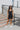 Full body view of model wearing the Comfort Zone Lightweight Romper which features stretchy black fabric, a scooped neckline, a racerback, a built in bra, and fitted shorts.