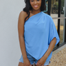 Front view of model wearing the Tried-and-True Blue Top which features blue fabric, an off-the shoulder neckline, and one short sleeve.