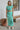 Full body front view of model wearing the Mint To Be Top that has mint green ribbed fabric, a cropped waist, a round neckline, and short sleeves