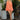 Full body front view of model wearing the Take Me To The Tropics Romper that has coral fabric, an elastic waist, a tie around the waist, an off-the-shoulder neck, and 3/4 flare sleeves with ruffle trim.