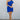 Full body front view of model wearing the In Your Dreams Dress that has royal blue fabric, royal blue lining, a wrap waist, a ruffle hem, one shoulder with a short sleeve, and a monochromatic side zipper with a hook closure.