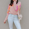 Front view of model wearing the Mila Pink Multi Long Sleeve Sweater which features orange, peach, cream and fuschia knit fabric, an upper floral print, ribbed hem, a ribbed round neckline, dropped shoulders, and long sleeves with ribbed cuffs.