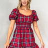 Front view of model wearing the Phoebe Red Multi Check Short Puff Sleeve Mini Dress which features red, blue, green, yellow and white knit fabric, plaid pattern, mini length, flared skirt hem, smocked waist with ruffles detail, scooped neckline and short 