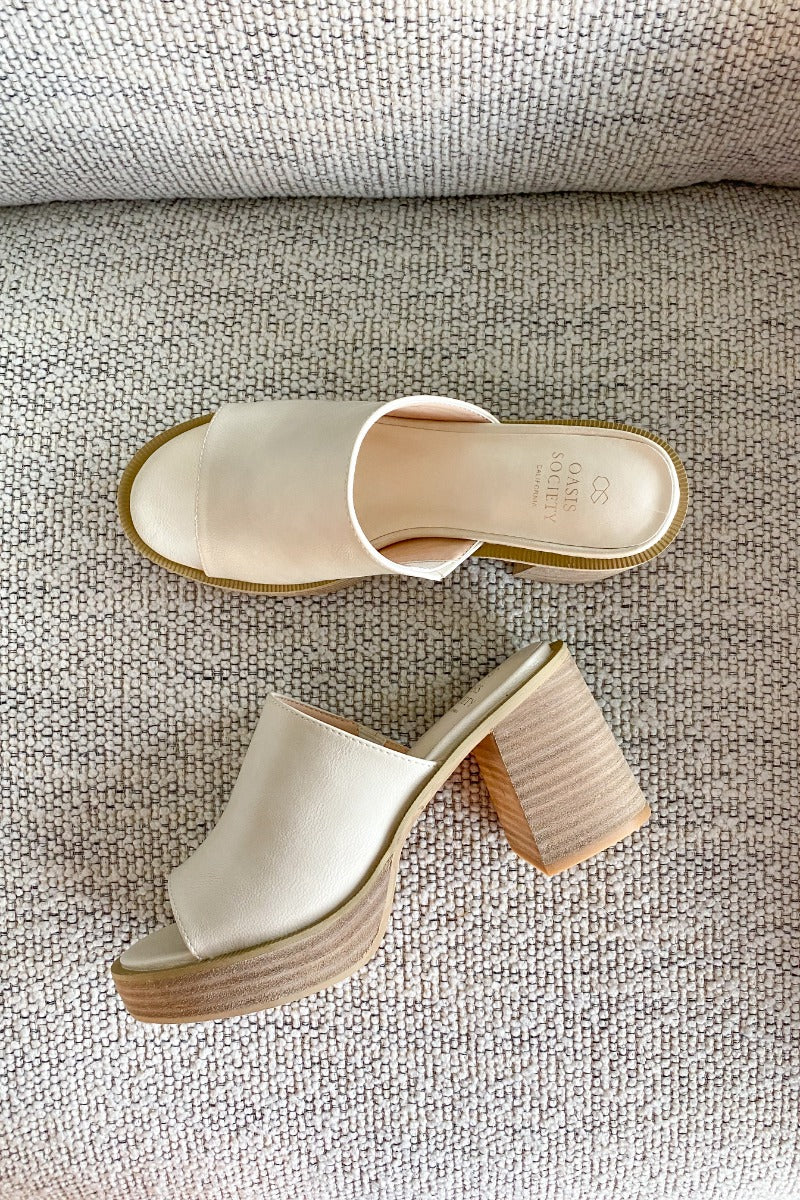 Aerial view of the Camille Platform Mules that feature a beige faux-leather upper, slide entry, a 1" platform, and a 3.5" block heel