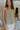 Front view of model wearing the Smooth Talker Tank Top that has dark sage fabric with a lining, a v-neckline, and spaghetti straps.