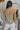 Back view of model wearing the Smooth Talker Tank Top that has dark sage fabric with a lining, a v-neckline, and spaghetti straps.